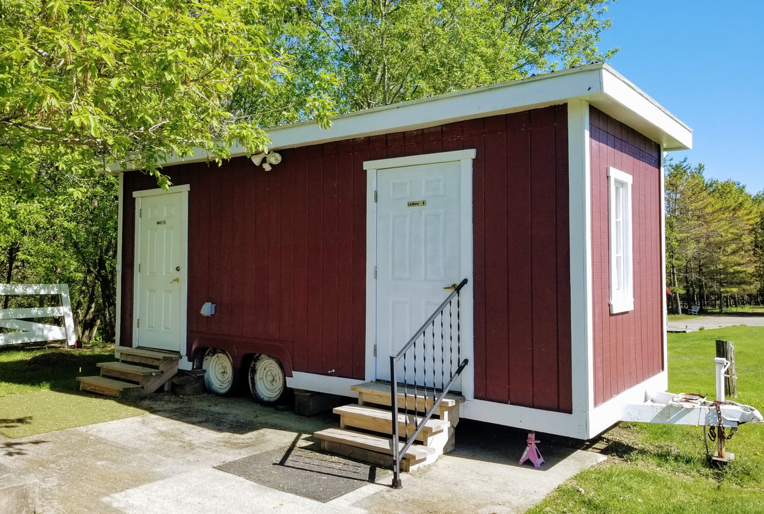 Use of this red and white barn themed bathroom house is included in our wedding venue package.